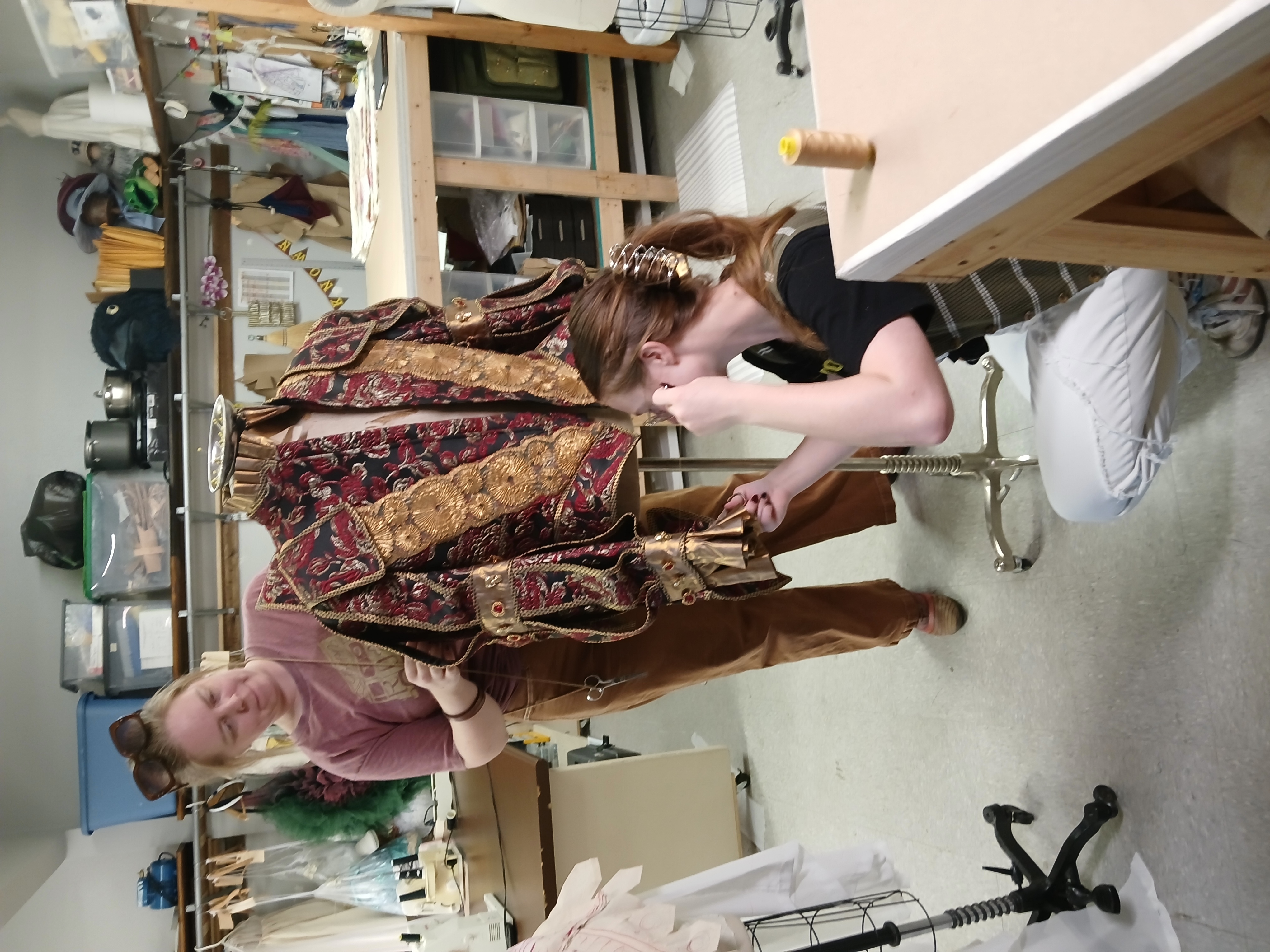 Two of the Hook & Eye team mid-build on the masquerade costume in the shop